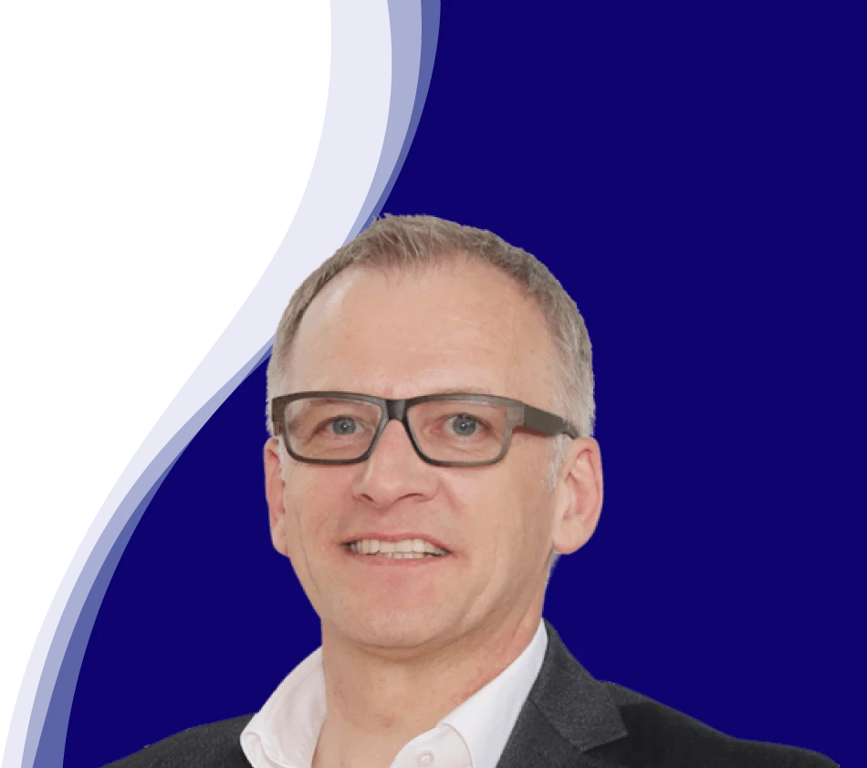 Wolfgang Maier, Head of Marketing at LEUCO, looks friendly into the camera. He is wearing distinctive dark glasses, a white shirt with an open collar and a dark jacket. His short hair is mottled gray.